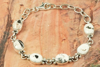 6 Beautiful White Buffalo Turquoise Stones set in Sterling Silver Link Bracelet. This Beautiful Stone is formed from the minerals Calcite and Iron. It is mined near Tonopah Nevada. This Beautiful Bracelet is a one of a kind Bracelet. The photo is of the jewelry you will be receiving. Created by Navajo Artist Geneva Chavez. Signed by the artist.